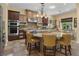 Bright kitchen with an island, seating and stainless appliances, perfect for entertaining guests and culinary adventures at 7206 Laramie Ave, Las Vegas, NV 89113