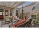 Inviting covered patio featuring comfortable wicker furniture and lush plants, perfect for relaxing outdoors at 7206 Laramie Ave, Las Vegas, NV 89113