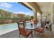 Covered patio boasts outdoor seating with a view of the pool, spa, and landscaped backyard at 7206 Laramie Ave, Las Vegas, NV 89113