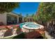 Lush backyard oasis with a sparkling pool, spa, mature trees, and comfortable lounge area, perfect for relaxation at 7206 Laramie Ave, Las Vegas, NV 89113