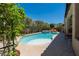 Relaxing pool and spa surrounded by lush landscaping in a private backyard setting on a sunny day at 7206 Laramie Ave, Las Vegas, NV 89113