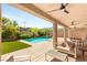 Inviting covered patio with a pool and comfortable seating, perfect for outdoor relaxation and entertaining at 749 Middle Beach St, Las Vegas, NV 89138