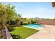 Lush backyard with a pool, green lawn, and mature trees, perfect for relaxation and outdoor enjoyment at 749 Middle Beach St, Las Vegas, NV 89138
