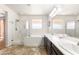 Bright bathroom with a double vanity, soaking tub, and glass-enclosed shower at 749 Middle Beach St, Las Vegas, NV 89138