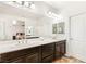Bathroom featuring a double vanity, large mirror, and excellent lighting at 749 Middle Beach St, Las Vegas, NV 89138