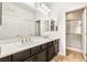 Bright bathroom featuring a dual sink vanity with modern fixtures and a glass-enclosed shower at 749 Middle Beach St, Las Vegas, NV 89138