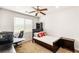 Well-lit bedroom with a comfortable bed, study space, and a window providing natural light at 749 Middle Beach St, Las Vegas, NV 89138