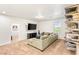 Cozy bonus room with a comfortable sectional sofa, TV and view to the hallway at 749 Middle Beach St, Las Vegas, NV 89138