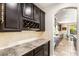 Elegant kitchen with granite countertops, wine storage, and stainless steel appliances at 749 Middle Beach St, Las Vegas, NV 89138