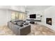 Spacious living room featuring a fireplace, tv, and natural light from the windows at 749 Middle Beach St, Las Vegas, NV 89138