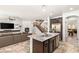 Open-concept living area with modern fireplace, spacious island, and staircase access at 749 Middle Beach St, Las Vegas, NV 89138