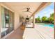 Enjoy outdoor living on this expansive patio with ceiling fans, a dining area, and access to a pool at 749 Middle Beach St, Las Vegas, NV 89138