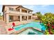 Gorgeous pool and spa with an attached basketball hoop, surrounded by a beautifully landscaped backyard at 749 Middle Beach St, Las Vegas, NV 89138