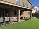 Back patio with outdoor kitchen, seating, turf, and ping pong table at 7855 Skyler Falls Ln, North Las Vegas, NV 89084
