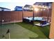 Backyard putting green with pergola, lounge furniture and festive lighting at 7855 Skyler Falls Ln, North Las Vegas, NV 89084