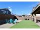 Backyard with artificial turf, gravel area, seating, and mountain views at 7855 Skyler Falls Ln, North Las Vegas, NV 89084