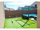 Backyard with putting green, lounge furniture, and string lights at 7855 Skyler Falls Ln, North Las Vegas, NV 89084
