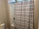 Bathroom featuring bathtub with horizontally striped shower curtain at 7855 Skyler Falls Ln, North Las Vegas, NV 89084