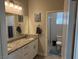 Bright bathroom featuring dual sinks with granite countertops and a separate toilet room at 7855 Skyler Falls Ln, North Las Vegas, NV 89084
