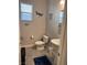 Well-lit half-bathroom featuring a pedestal sink, toilet, and stylish decor at 7855 Skyler Falls Ln, North Las Vegas, NV 89084