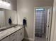 Bright bathroom featuring dual sinks with granite countertops and a separate toilet room at 7855 Skyler Falls Ln, North Las Vegas, NV 89084