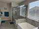 Primary bathroom featuring a tub, glass shower, and double sinks with modern fixtures at 7855 Skyler Falls Ln, North Las Vegas, NV 89084
