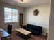 Bedroom featuring a futon, accent tables, and decorative wall art at 7855 Skyler Falls Ln, North Las Vegas, NV 89084
