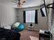 Comfortable bedroom with modern ceiling fan, window with blinds, and cozy furnishings at 7855 Skyler Falls Ln, North Las Vegas, NV 89084