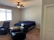 Bedroom with a bed, two recliners, and natural light at 7855 Skyler Falls Ln, North Las Vegas, NV 89084