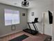 Bedroom featuring a treadmill and motivational decor at 7855 Skyler Falls Ln, North Las Vegas, NV 89084
