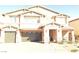 Inviting two-story home featuring a three-car garage and landscaped front yard at 7855 Skyler Falls Ln, North Las Vegas, NV 89084