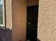 Close-up of a secure front door with a modern lock and peephole at 7855 Skyler Falls Ln, North Las Vegas, NV 89084