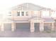 Charming two-story home with a three-car garage, a stone veneer and a well manicured brick driveway at 7855 Skyler Falls Ln, North Las Vegas, NV 89084