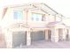 Charming two-story home with a three-car garage, a stone veneer and a well manicured brick driveway at 7855 Skyler Falls Ln, North Las Vegas, NV 89084