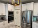 Modern kitchen featuring stainless steel appliances, a pantry and granite countertops at 7855 Skyler Falls Ln, North Las Vegas, NV 89084