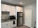 Well-equipped kitchen with white cabinetry, granite countertops, and stainless steel appliances at 7855 Skyler Falls Ln, North Las Vegas, NV 89084