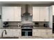 Bright kitchen featuring white cabinets, granite countertops, and stainless steel appliances at 7855 Skyler Falls Ln, North Las Vegas, NV 89084