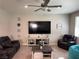 Comfortable living room with a large TV and plush seating at 7855 Skyler Falls Ln, North Las Vegas, NV 89084