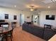 Spacious living room, plush carpet, a ceiling fan, a game table, and a comfortable seating area at 7855 Skyler Falls Ln, North Las Vegas, NV 89084