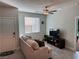 Inviting living room with a comfortable sofa, TV, and neutral decor at 7855 Skyler Falls Ln, North Las Vegas, NV 89084