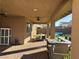 Covered patio boasts brick pavers, ceiling fans, and outdoor seating perfect for entertaining at 7855 Skyler Falls Ln, North Las Vegas, NV 89084