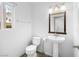 Cozy half bathroom with pedestal sink, classic fixtures, and a window allowing for natural light at 8733 Country Pines Ave, Las Vegas, NV 89129