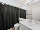 Bathroom with a large mirror, ample lighting, and a shower with a dark shower curtain at 8733 Country Pines Ave, Las Vegas, NV 89129