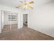 The bedroom has neutral carpet, sliding mirror closet, and a ceiling fan for added comfort at 8733 Country Pines Ave, Las Vegas, NV 89129