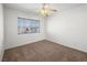 Spare bedroom features neutral carpet, a window for natural light, and simple interior design at 8733 Country Pines Ave, Las Vegas, NV 89129