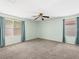 Spacious bedroom featuring soft carpet, ceiling fan, and two windows that provides natural light at 8733 Country Pines Ave, Las Vegas, NV 89129