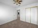 Comfortable bedroom with neutral carpet, a ceiling fan, and a mirrored closet for storage at 8733 Country Pines Ave, Las Vegas, NV 89129
