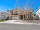 Charming two-story home featuring a classic design with a red tile roof and an attached two-car garage at 8733 Country Pines Ave, Las Vegas, NV 89129