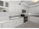 Well-lit kitchen with granite countertops, white cabinets, and stainless steel appliances at 8733 Country Pines Ave, Las Vegas, NV 89129
