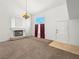 Spacious living room with plush carpeting, high ceilings, a chandelier, and a cozy fireplace at 8733 Country Pines Ave, Las Vegas, NV 89129